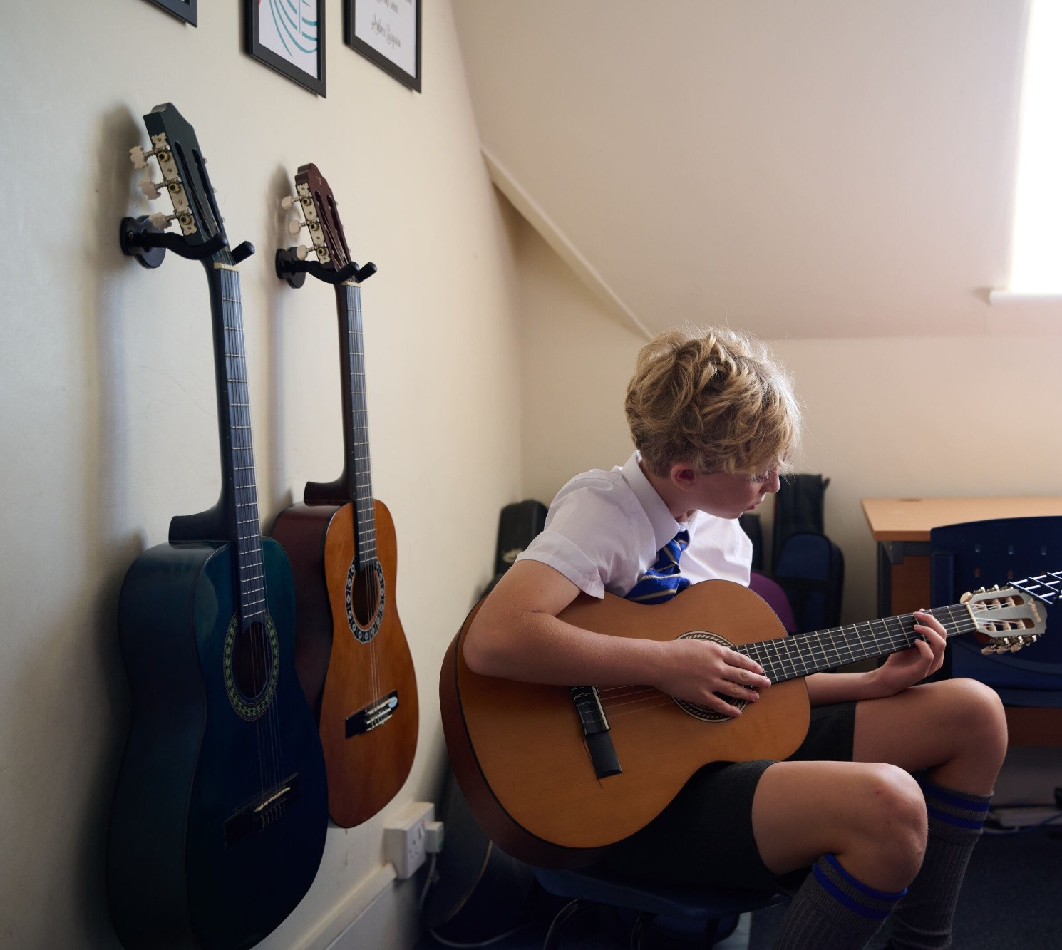 Loyola boy playing the guitar