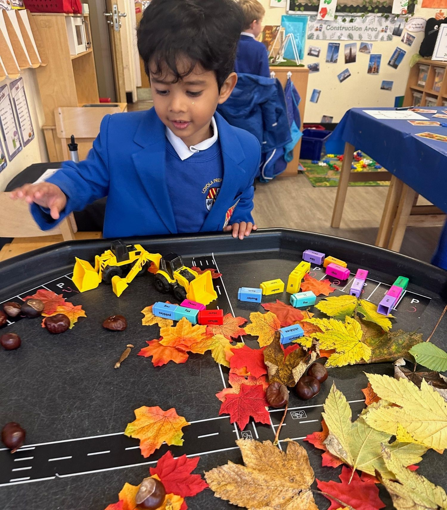 Loyola boy playing with leaves